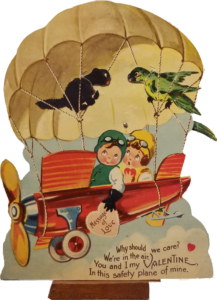 Mechanical Valentine card children in aeroplane with parachute