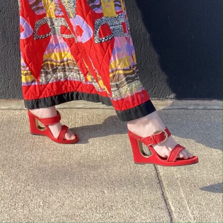 woman's feet in red wedges