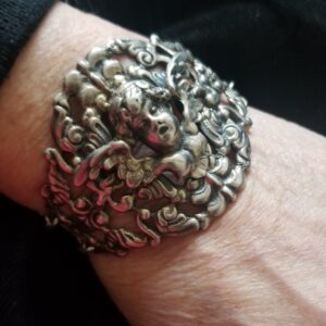 Silver Cherub bracelet on hand