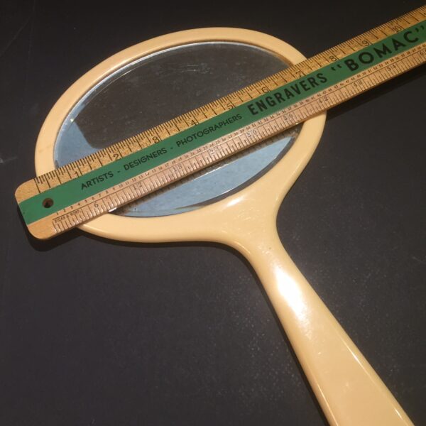 French ivory mirror. Length from top to tip of handle proximally 13 1/2 inches. Oval mirror,