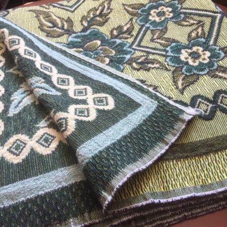 Multi tone woven green bedspread or throw
