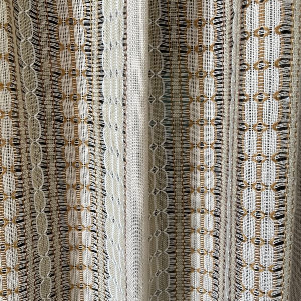 One beige and brown tone open weave single panel. One corner of the top has been cut off, and there’s a hole in the center. Approximate size 18” wide by 72” long.