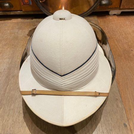 Pith helmet with original metal carrying case. Made by Gieves Limited of London and Edinburgh. Size 7. Hat belonged to Capt. J. S. M. Ritchie , R. N