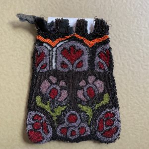 Antique black beaded pouch with floral motif.