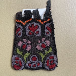 Black beaded pouch with floral motif.